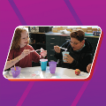 Two teens playing with putty at a table